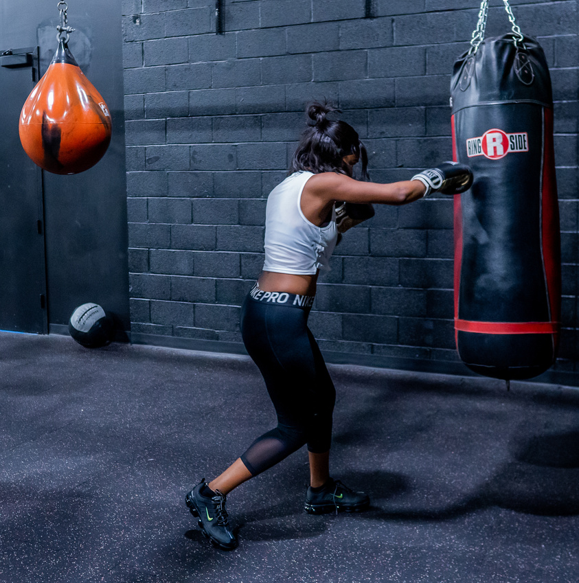 A Woman Hitting the Punching Bag